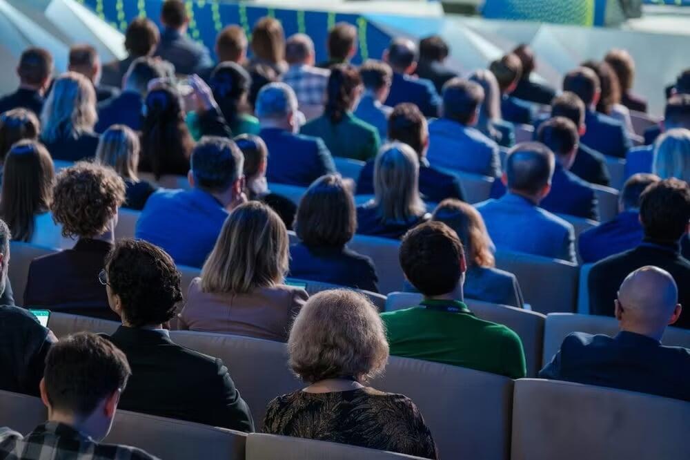 corporate event with people sitting and watching